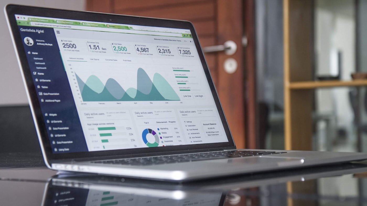 A laptop on a desk showing a reporting dashboard