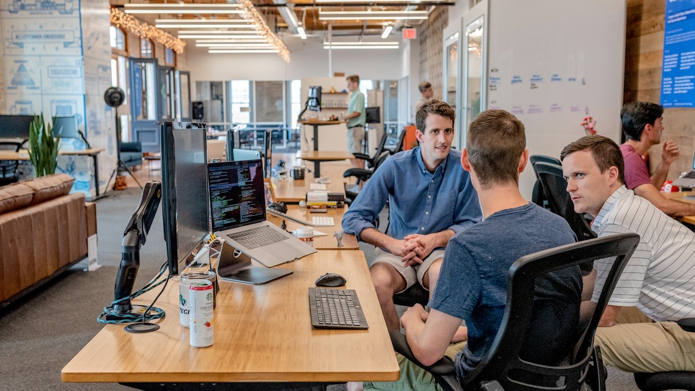An open-plan office with a marketing team working at their desks